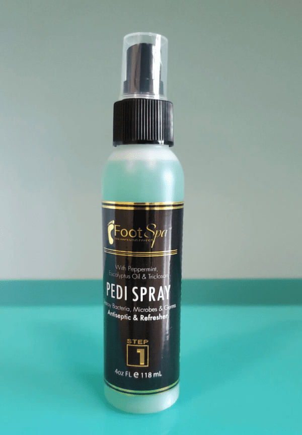 A bottle of Pedi Spray 4oz on a table.