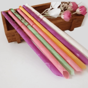A group of colorful ear candles in a wooden box.