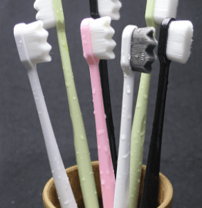 A group of Black Micro Bristles Toothbrushes in a cup.
