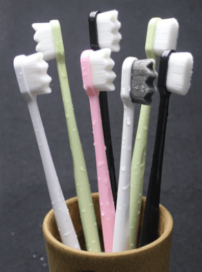A group of Black Micro Bristles Toothbrushes in a cup.