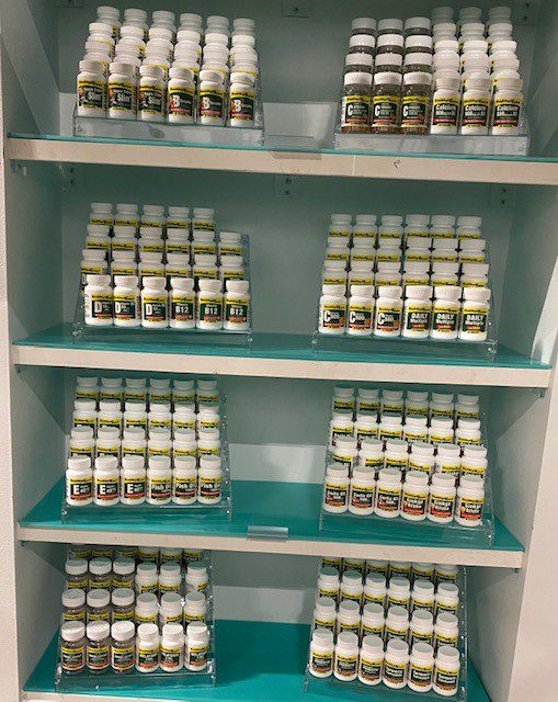 A shelf with a lot of Vitamin-E 45mg jars on it.
