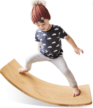 A young boy is standing on a Waist Training-Wooden Balance Board.