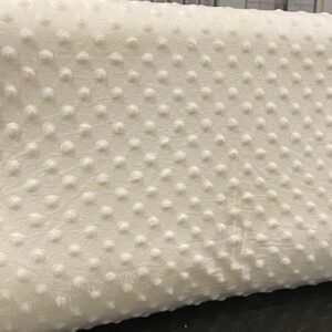 A Memory Foam Pillow with polka dots on it.