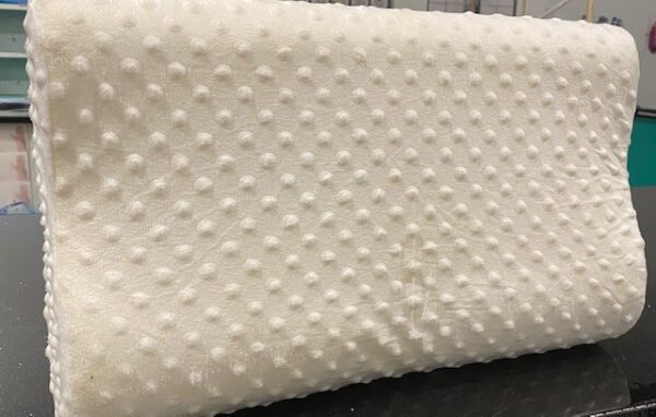 A Memory Foam Pillow with polka dots on it.