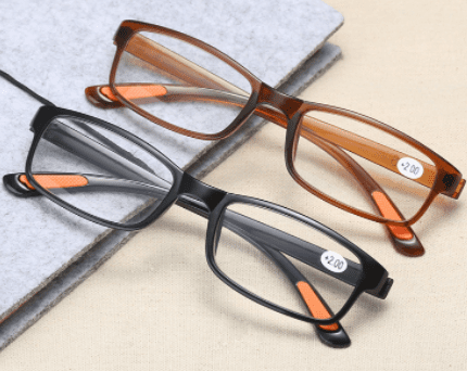 Two pairs of Reading Glasses Men/Women tr90 reading glasses on a table.